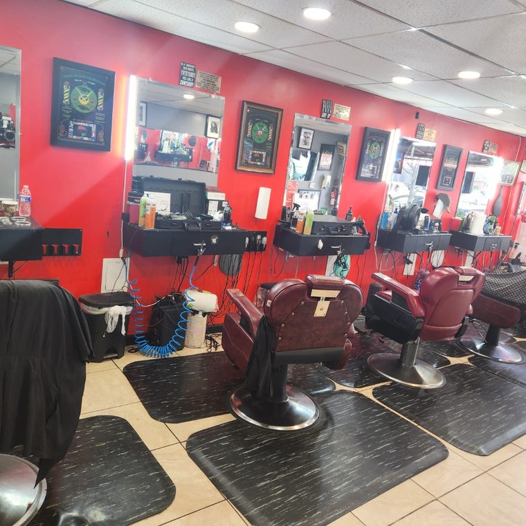 Inside Lilacroix Barbers — barber chairs and red wall